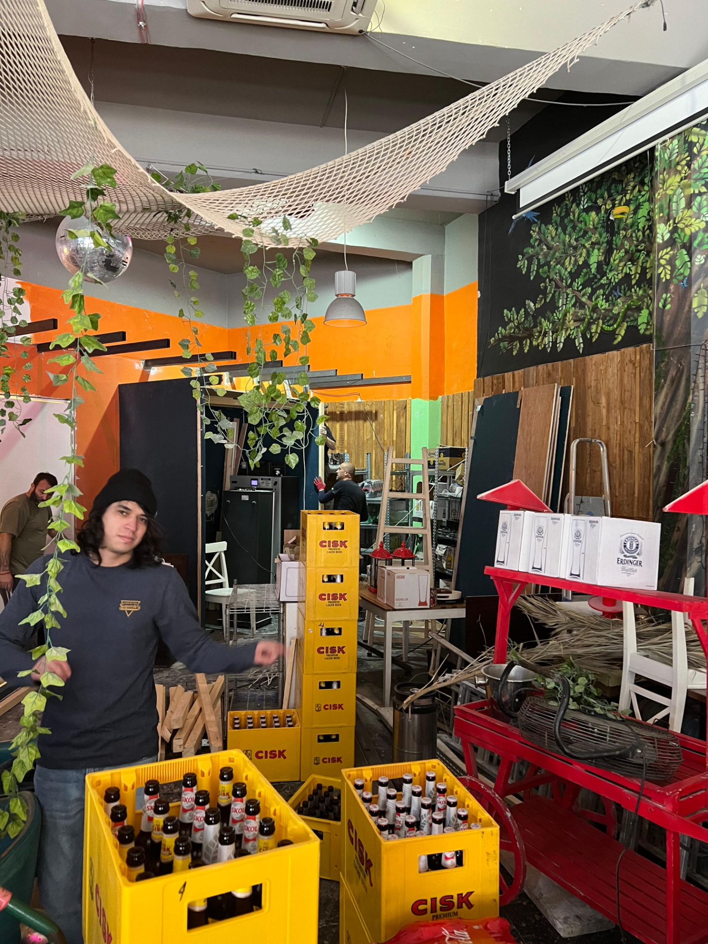 Build days in the jungle — crates, vines and a grin.