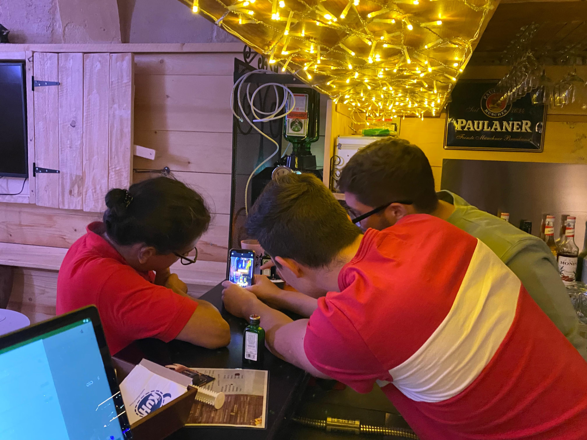 Heads together at the bar, plotting the next silly idea.